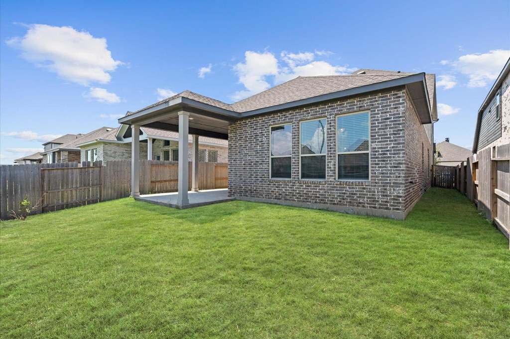 A house with a green lawn in front.