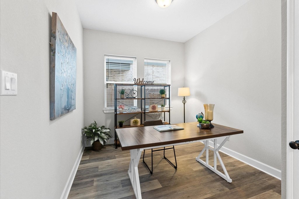 A room with a table and a plant.