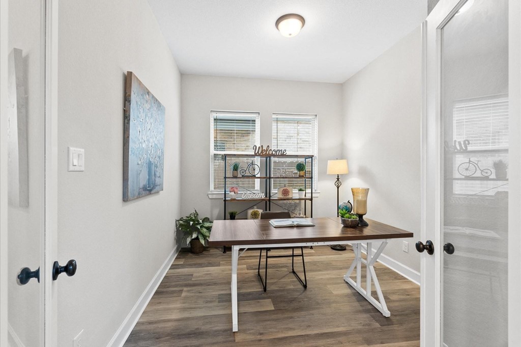 A dining room with a table and chairs.