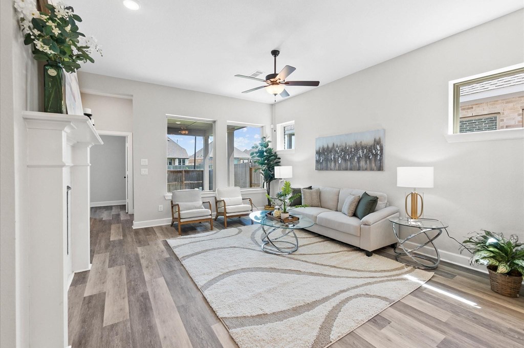 A living room with a white couch, a coffee table, and a Christmas tree.
