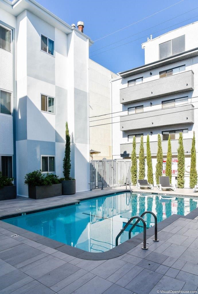 a large swimming pool in front of a building