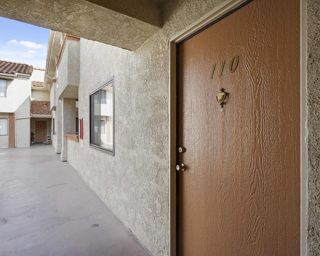 A brown door with the number 110 on it.