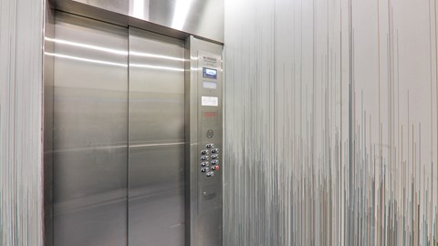 a stainless steel elevator in a building