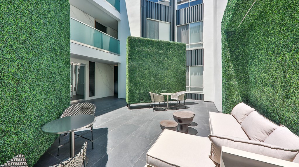 a communal area with a green wall and furniture