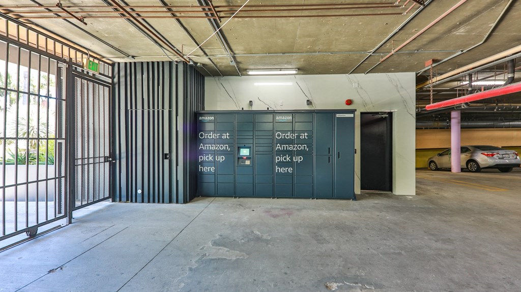 the inside of a building with a garage door and a parking lot
