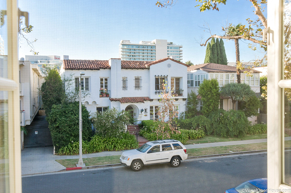 a white car parked in front of a house on a street