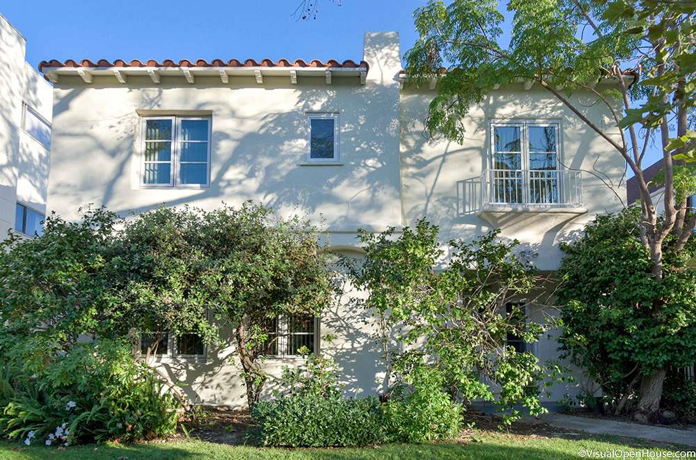 a white house with trees in front of it