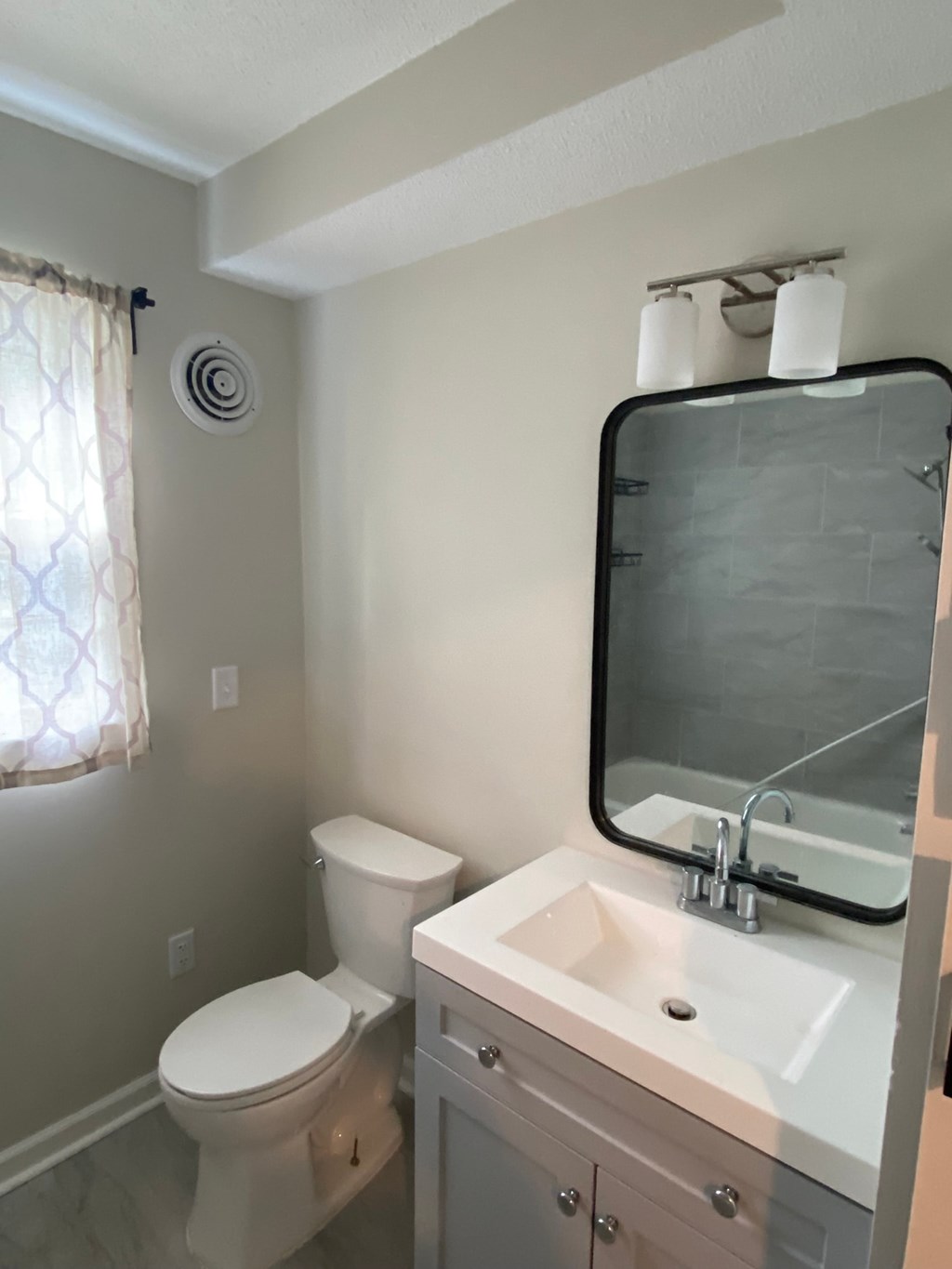 a bathroom with a sink toilet and a mirror