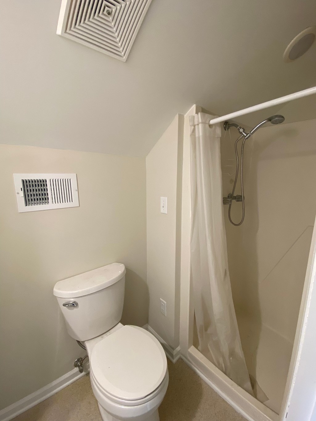 a small bathroom with a toilet and a shower