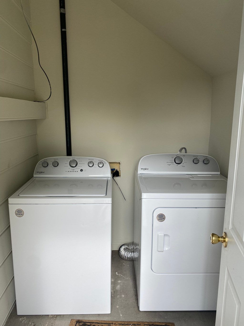 two washers and a dryer in a laundry room
