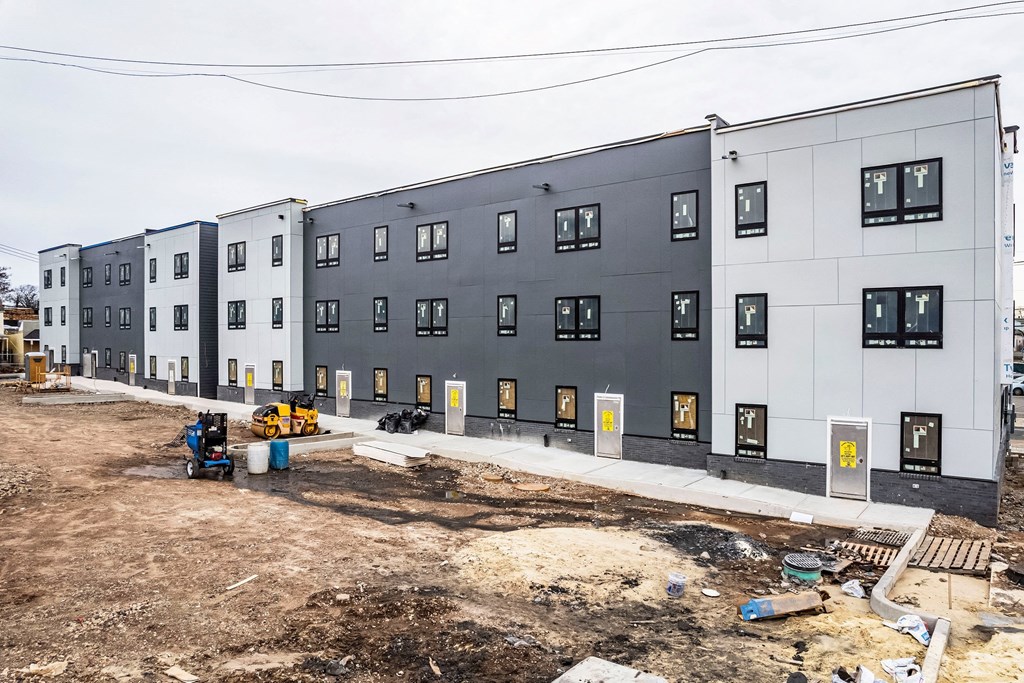 a large building with a construction site in front of it