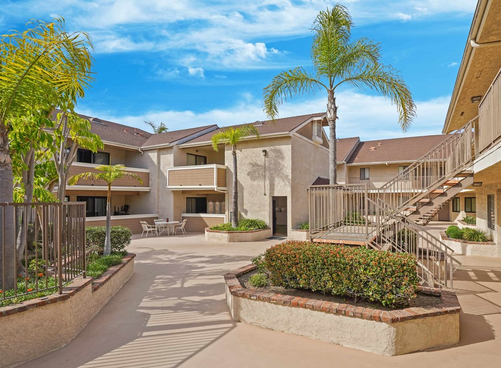 A sunny day at a residential complex with a clear blue sky.