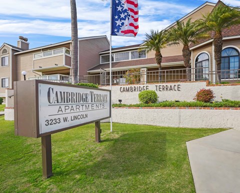 A sign for Cambridge Terrace Apartments stands in front of a building.