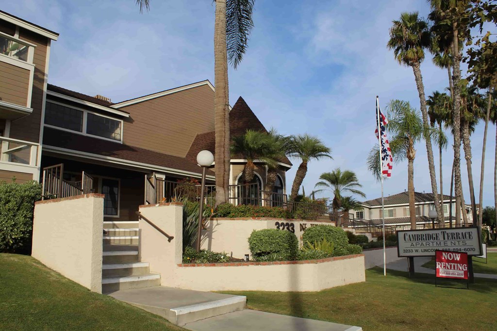 A building with a sign that says "Cambridge Terrace Apartments" in front of it.