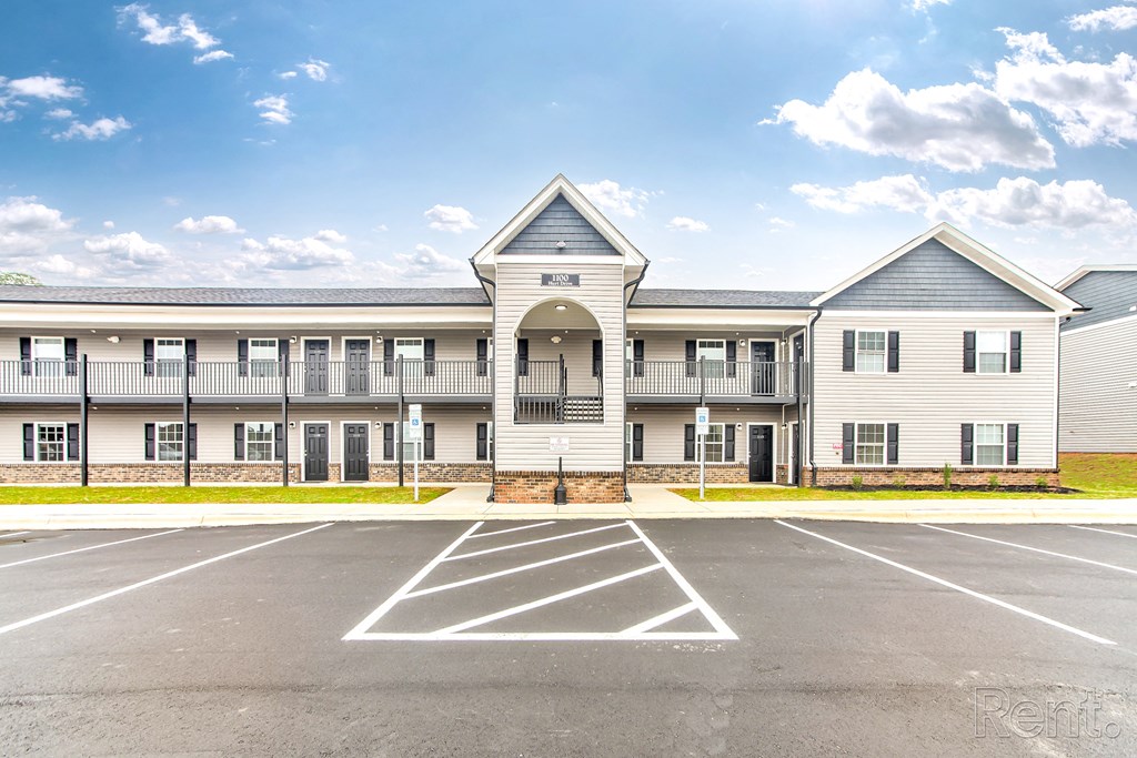 A large building with a parking lot in front of it.