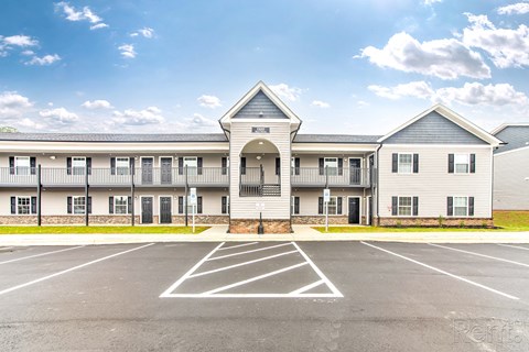 A large building with a parking lot in front of it.