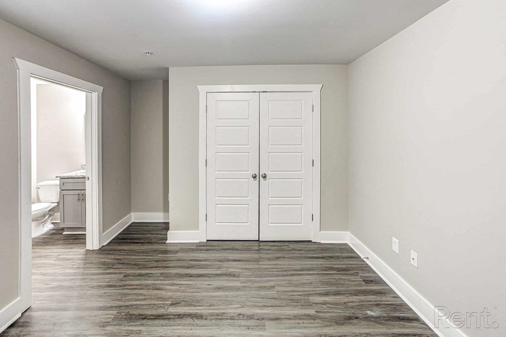 A room with a white door and a white cabinet.