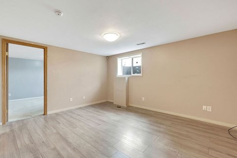 a living room with a mirror and a door to a closet