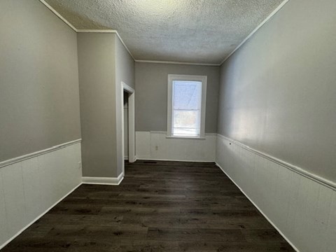 A room with a window and a door.