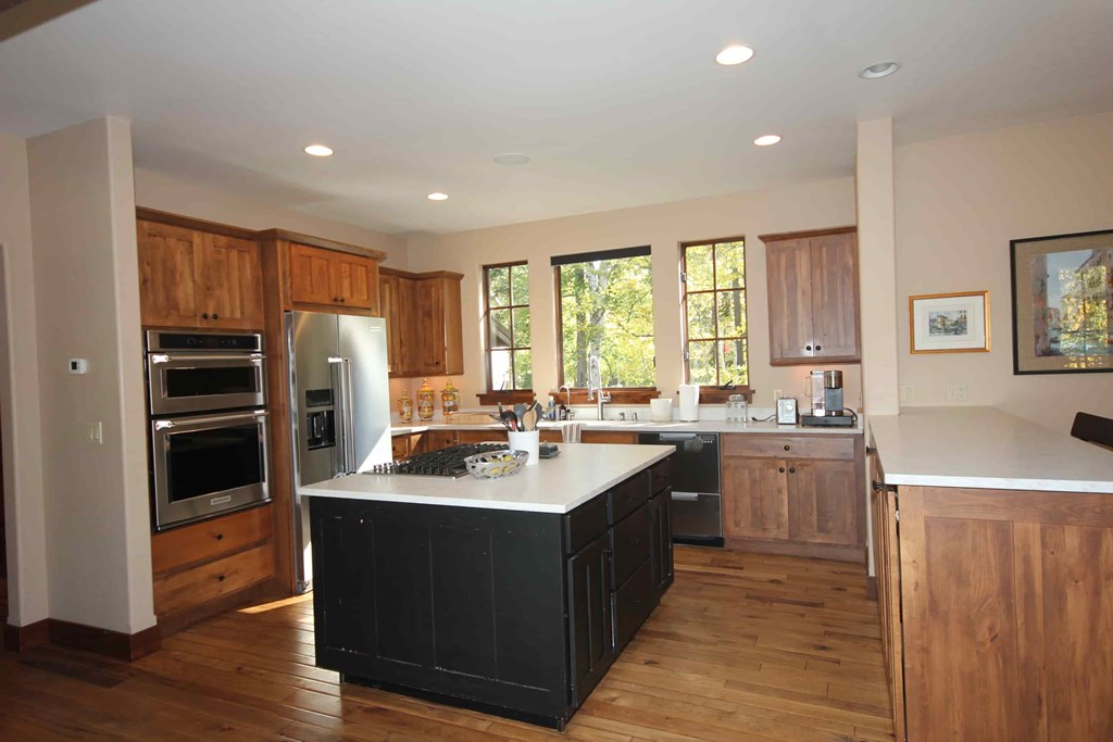 a large kitchen with a center island and stainless steel appliances