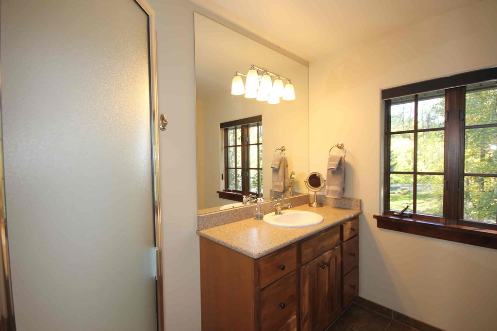 an updated bathroom with a sink and a mirror