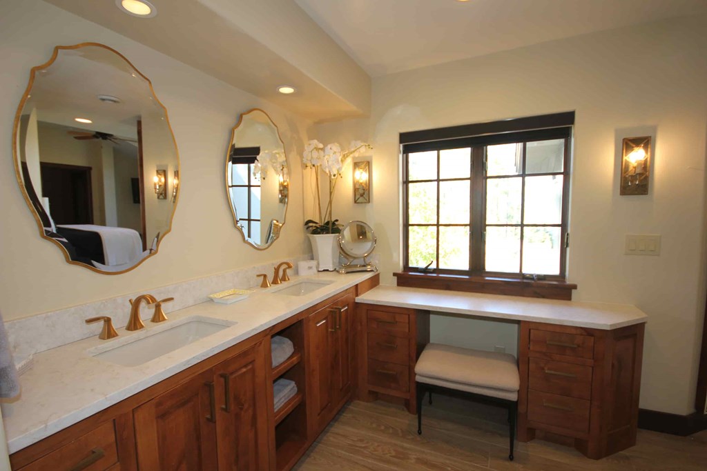 a large bathroom with two sinks and two mirrors