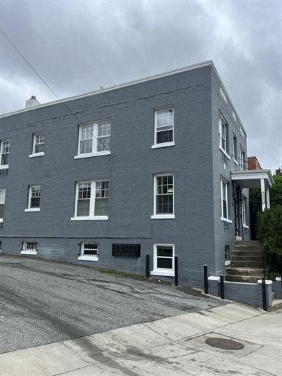 a blue building on the side of a street