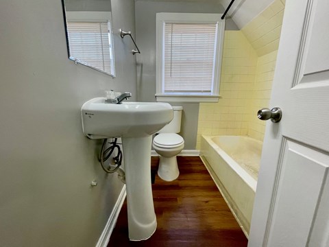 A white sink and toilet in a small bathroom.