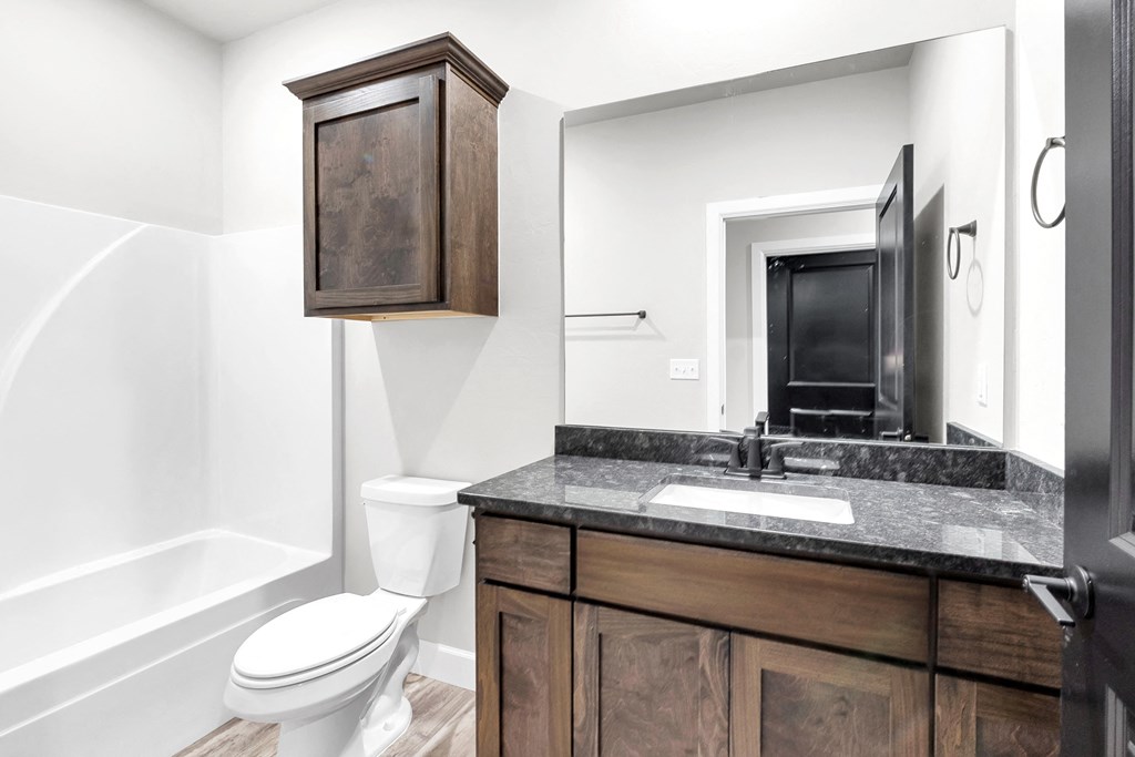 a bathroom with a toilet sink and a mirror