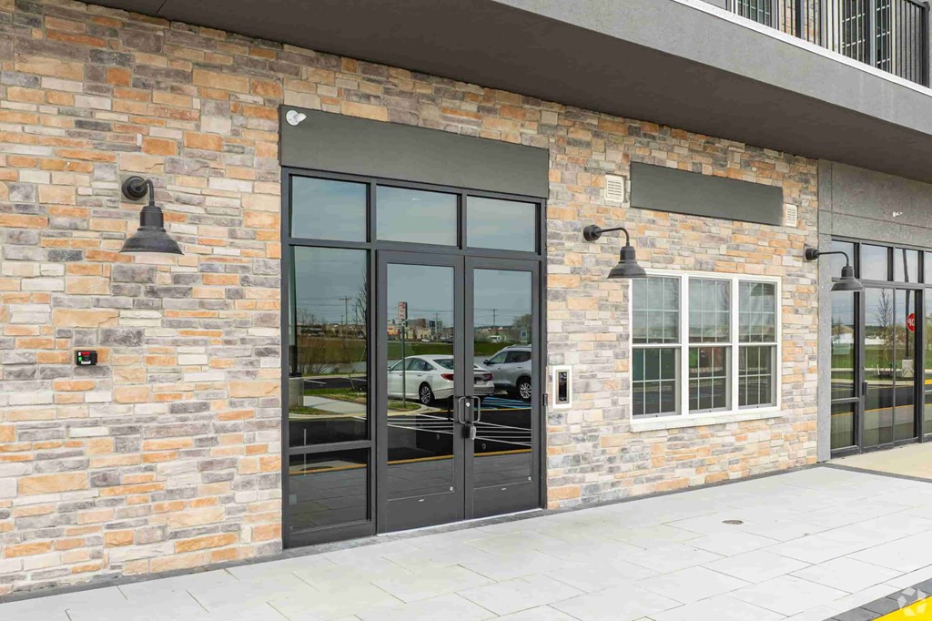 A building with a brick wall and a black door.