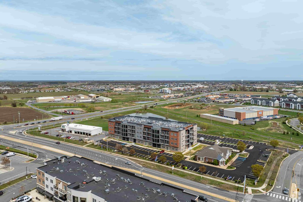 A large building with a parking lot in front of it.