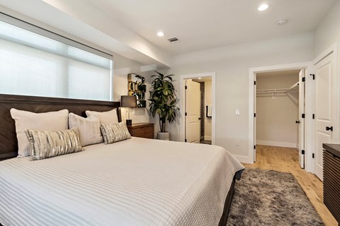 a bedroom with a large bed and a closet