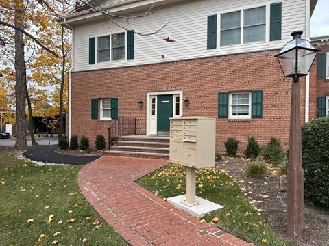 A house with a green door and a mailbox in front.