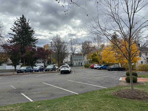 A parking lot with cars and trees.