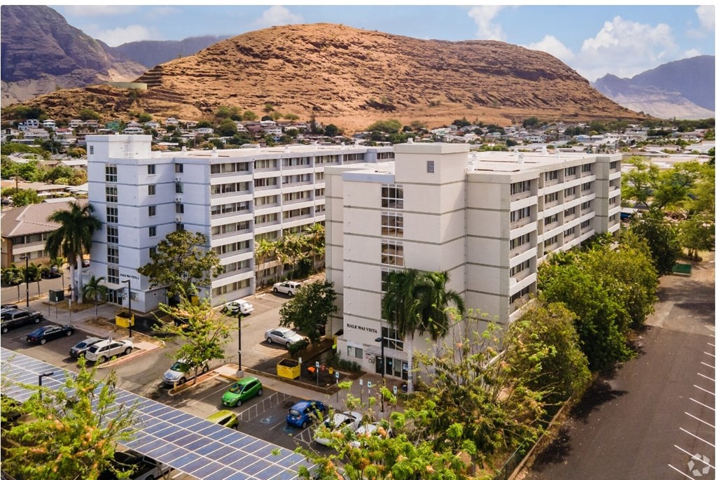 an aerial view of an apartment complex with a mountain in the background