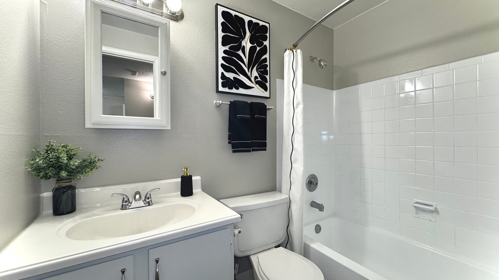 a kitchen and living room with a black refrigerator