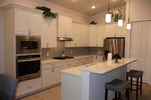 a kitchen with white cabinets and a counter top