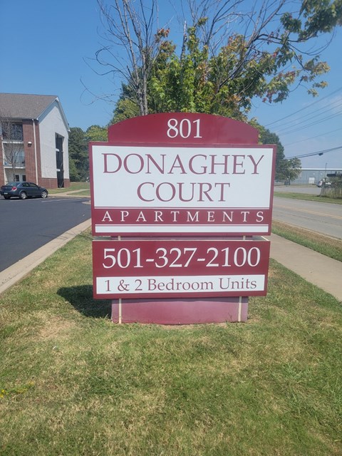 A sign for Donaghey Court Apartments with a phone number and a note that there are 1 and 2 bedroom units.