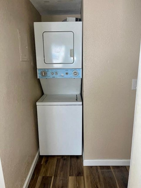 a white refrigerator and a washing machine in a room