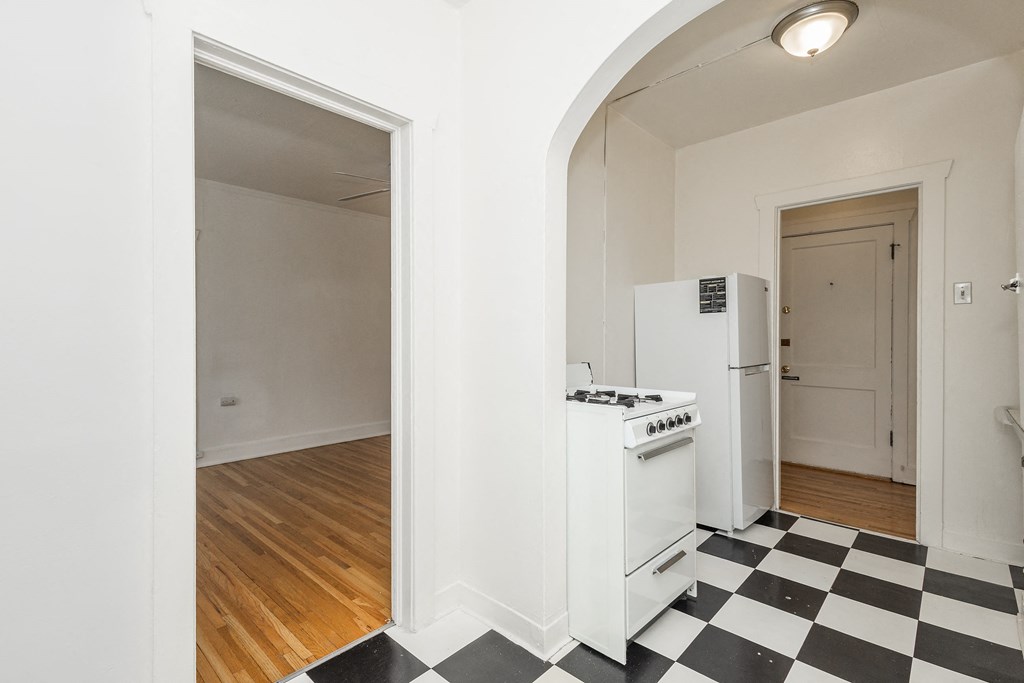 A black and white checkered floor in a kitchen.