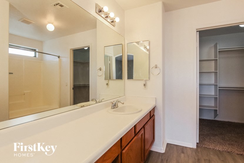 a bathroom with a large mirror and a sink