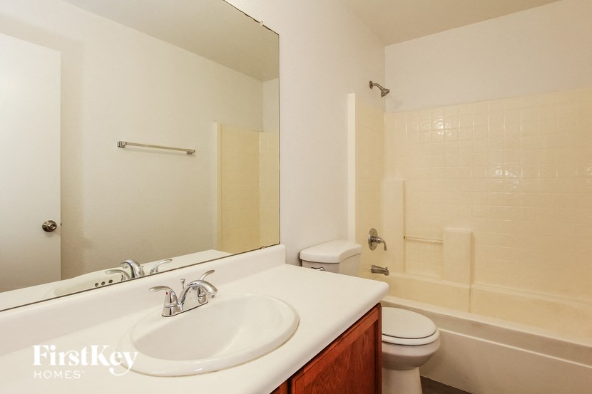 a bathroom with a sink and a toilet and a shower