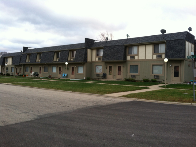 Apartment complex with a grey road in front.