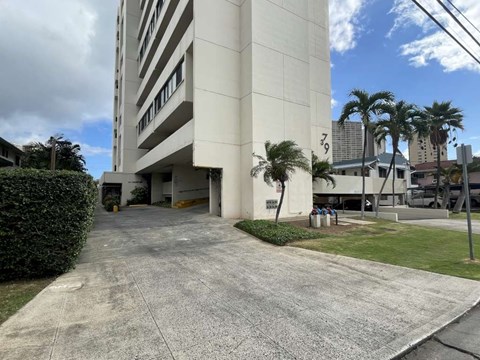 A tall white building with the number 79 on it.