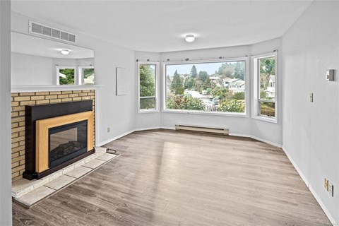 A living room with a fireplace and a view of the outdoors.