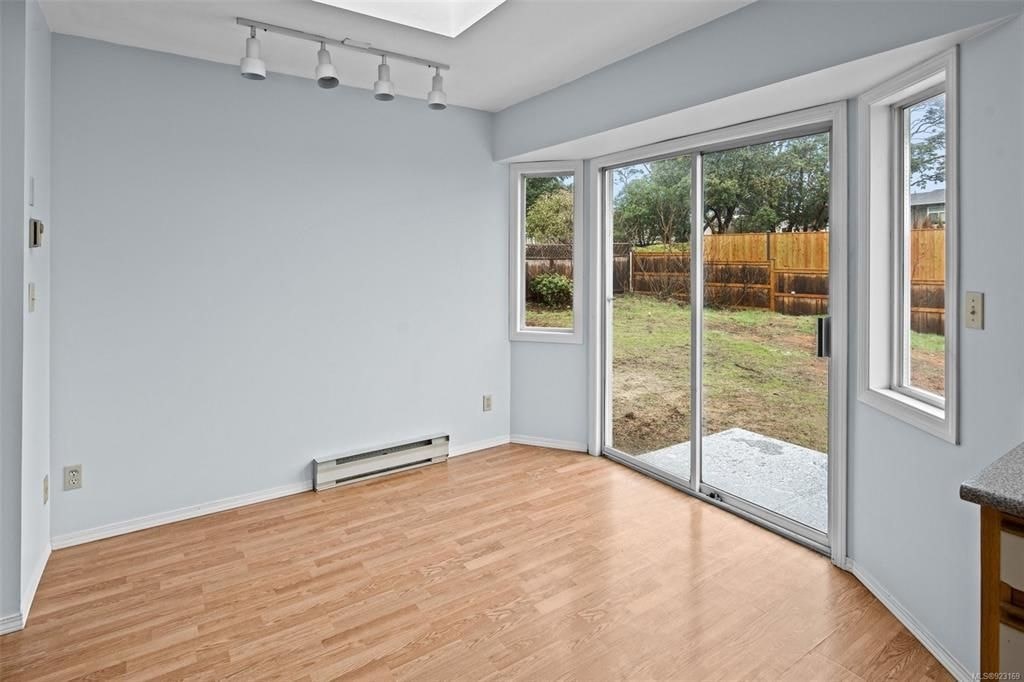 A room with a sliding glass door leading to a backyard.