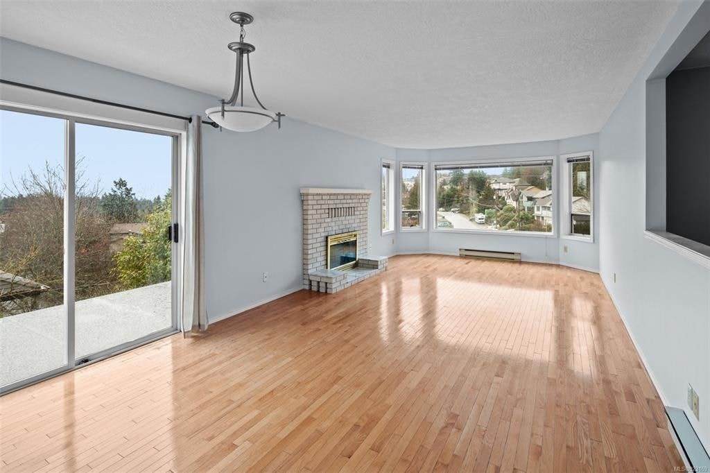 A room with wooden floors and a fireplace.