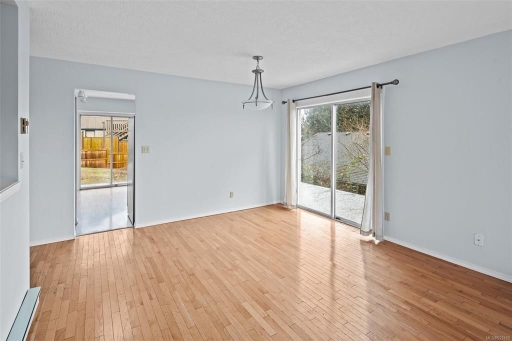 A room with a sliding glass door leading to a balcony.