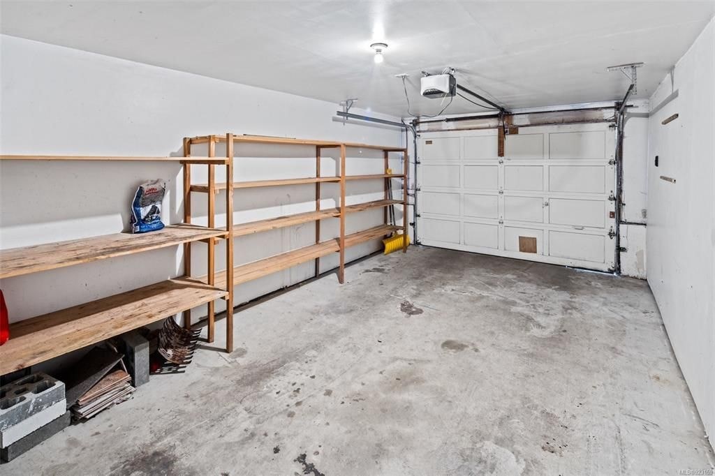 A garage with a white wall and a white door.