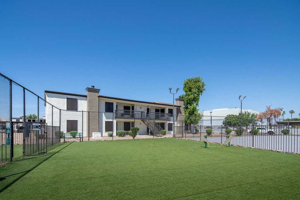 A modern building with a green lawn in front.